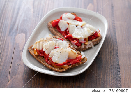 corn bread with cod fish and courgette on white dish 78160807