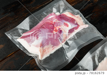 Vacuum packed raw duck breast, on old dark wooden table background 78162679