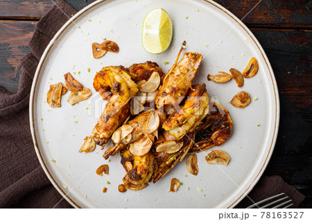 Grilled Mango Prawns or shrimps, on plate, on old dark wooden table background, top view flat lay Grilled Mango Prawns or shrimps, on plate, on old dark wooden table background, top view flat lay 78163527
