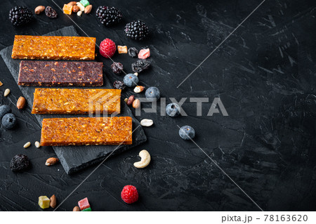 Fruit berry and nut energy bars, healthy snack, flat lay with space for text,on black background Fruit berry and nut energy bars, healthy snack, flat lay with space for text,on black background 78163620