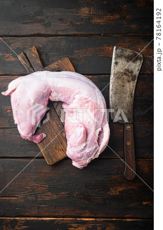 Fresh raw rabbit meat, and old butcher cleaver knife, on old dark wooden table , top view flat lay, with copy space for text Fresh raw rabbit meat, and old butcher cleaver knife, on old dark wooden table , top view flat lay, with copy space for text 78164192