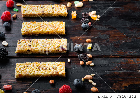 Superfood breakfast bars with oats nuts and berries with copy space, on wooden table 78164252
