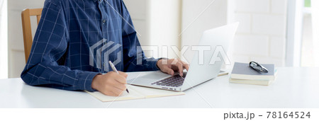 Young asian business man in face mask for protect covid-19 and work on laptop computer. Young asian business man in face mask for protect covid-19 and work on laptop computer. 78164524