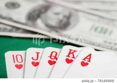 Royal flush of hearts cards during poker with dollars on green table. Royal flush of hearts cards during poker with dollars on green table. 78166866