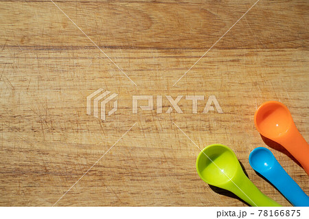 Used kitchen cutting board with measuring spoons 78166875