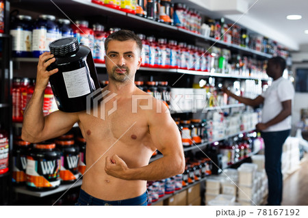 man holding cans of sports nutrition man holding cans of sports nutrition 78167192