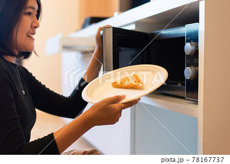 Young Beautiful Woman Using Microwave Oven Stock Photo 317199641