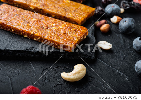 Healthy fitness energy bars with dried fruits with copy space,on black background Healthy fitness energy bars with dried fruits with copy space,on black background 78168075