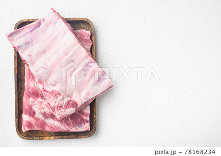 Pork rib, on wooden serving board, on white stone background, top view flat lay, with copy space for text Pork rib, on wooden serving board, on white stone background, top view flat lay, with copy space for text 78168234