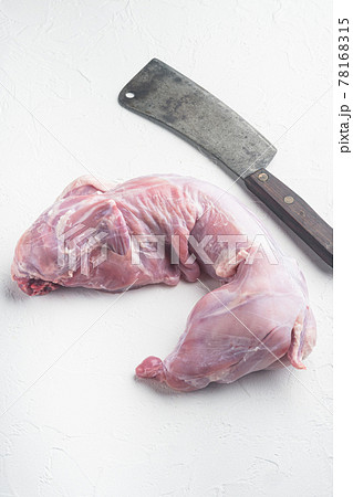 Whole rabbit meat, and old butcher cleaver knife, on white stone background 78168315