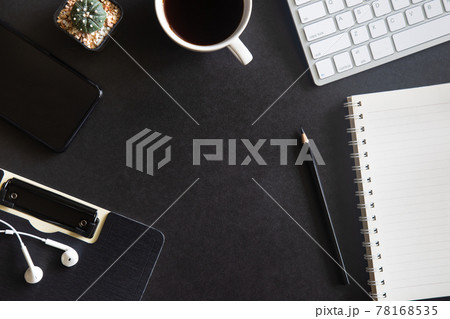 Black desk office with laptop, smartphone and other work supplies with cup of coffee. Top view with copy space for input the text. Designer workspace on desk table essential elements on flat lay. Black desk office with laptop, smartphone and other work supplies with cup of coffee. Top view with copy space for input the text. Designer workspace on desk table essential elements on flat lay. 78168535