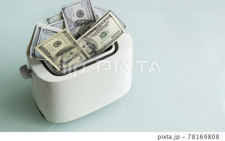 US Hundred dollar bills burning in the toaster. US dollars roasting in toaster. Financial concept. 78169808