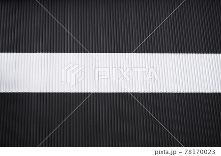 Black and white corrugated iron sheet used as a facade of a warehouse or factory. Texture of a seamless corrugated zinc sheet metal aluminum facade. Architecture. Metal texture. Black and white corrugated iron sheet used as a facade of a warehouse or factory. Texture of a seamless corrugated zinc sheet metal aluminum facade. Architecture. Metal texture. 78170023