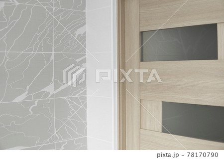 Interior doors on the kitchen side with white and gray tiles on the wall. Interior doors on the kitchen side with white and gray tiles on the wall. 78170790