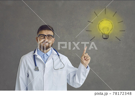 Portrait of proud doctor pointing at light bulb as symbol of innovative ideas and solutions Portrait of proud doctor pointing at light bulb as symbol of innovative ideas and solutions 78172348