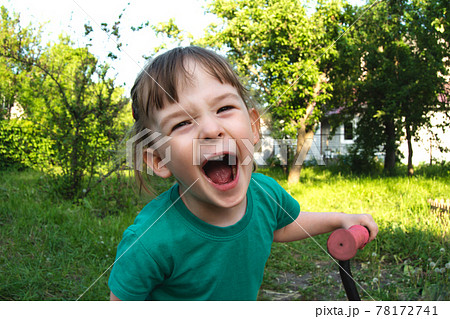 Portrait of a happy cheerful child outdoors Portrait of a happy cheerful child outdoors 78172741