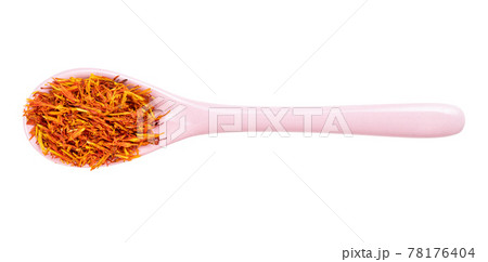 dried safflower petals in ceramic spoon isolated dried safflower petals in ceramic spoon isolated 78176404