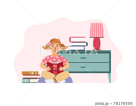 Young cute kid girl sitting and read book at home, library or kindergarten. 78176500