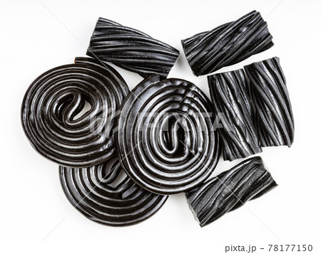 several black liquorice candies close up on white several black liquorice candies close up on white 78177150