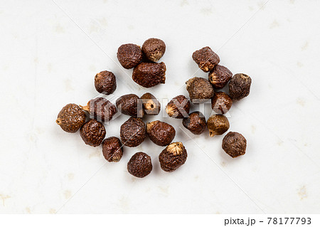 several grains of paradise pepper close up on gray several grains of paradise pepper close up on gray 78177793