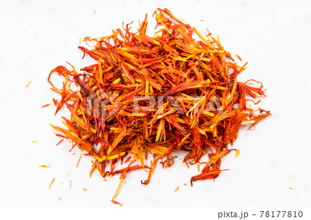 pile of dried safflower petals close up on gray 78177810