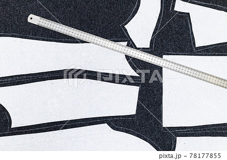 paper layout of sewing patterns and steel ruler 78177855