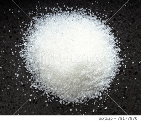 pile of white refined beet sugar close up on black 78177970