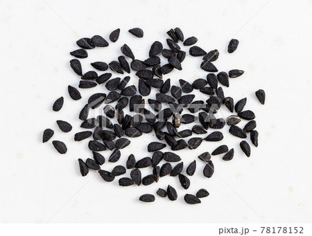 several Nigella sativa seeds close up on gray 78178152