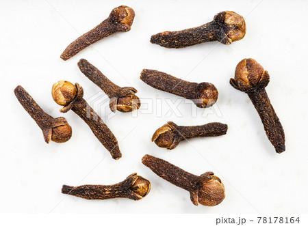 several whole dried cloves close up on gray several whole dried cloves close up on gray 78178164