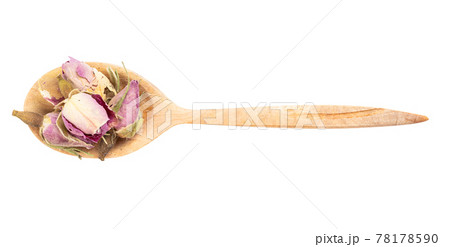 top view of dried rosebuds in wood spoon isolated 78178590
