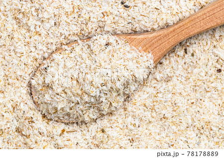 top view of wood spoon with psyllium husk close up 78178889