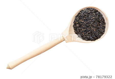 top view of whole-grain niger seeds in wood spoon 78179322