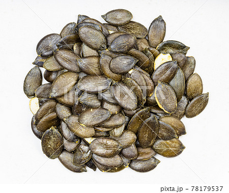 pile of styrian pumpkin seeds close up on gray 78179537