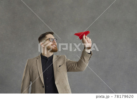 Successful businessman throws a paper plane as a sign to start his business project. Successful businessman throws a paper plane as a sign to start his business project. 78179620