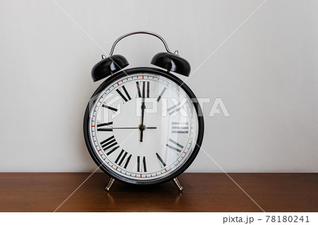 Vintage analog alarm clock on the wooden table Vintage analog alarm clock on the wooden table 78180241