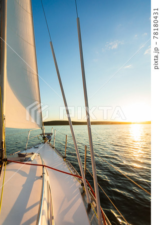Yacht Sailing In Sea At Sunset On Summer Day, Vertical Yacht Sailing In Sea At Sunset On Summer Day, Vertical 78180431