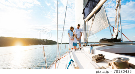 Family Enjoying Yacht Ride Standing On Deck And Holding Hands Family Enjoying Yacht Ride Standing On Deck And Holding Hands 78180435