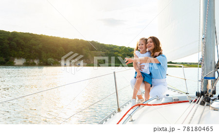 Cheerful Mother And Daughter Enjoying Sailing During Yacht Ride Tour 78180465