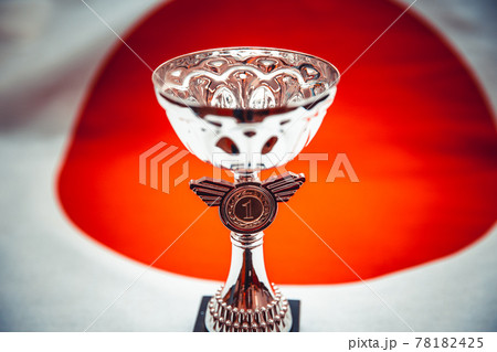 A sports cup on the background of the Japanese flag, wallpaper for sports design. Photo in artistic processing 78182425