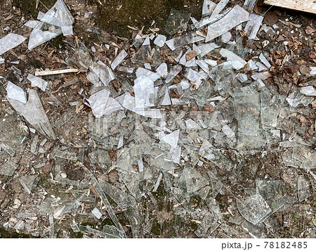 Broken glass, dirt on the ground, from broken windows. 78182485