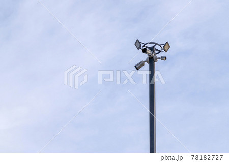 outdoor security camera on a lamppost against a blue sky outdoor security camera on a lamppost against a blue sky 78182727