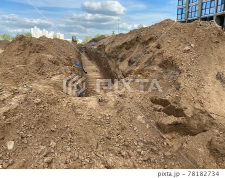 Large industrial modern new large diameter polyethylene plastic water pipes lie in a pit underground at a construction site during a water pipe repair Large industrial modern new large diameter polyethylene plastic water pipes lie in a pit underground at a construction site during a water pipe repair 78182734