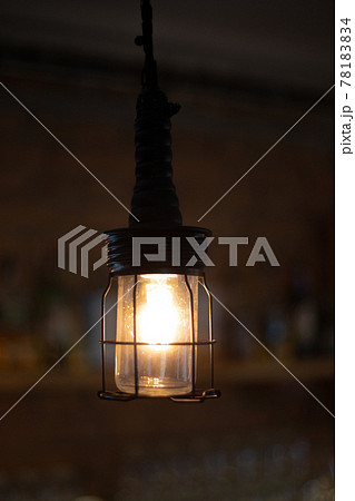 Lamp in metal grid lampshade, old floor lamp on blurred brown backdrop Lamp in metal grid lampshade, old floor lamp on blurred brown backdrop 78183834