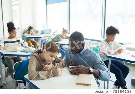 Teacher Helping Students in Class 78184152
