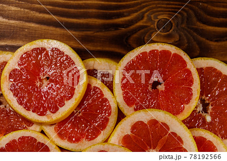 Sliced grapefruits on wooden table. Top view, copy space 78192566