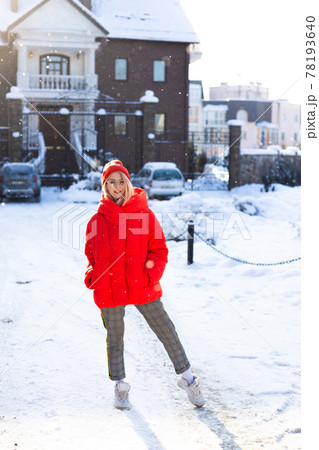 Young stylish blonde woman on the street has fun, posing in snowy, frosty 78193640