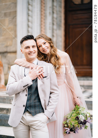 Smiling newlyweds hug on the steps at the entrance to the Basilica of Santa Maria Maggiore in Rome Smiling newlyweds hug on the steps at the entrance to the Basilica of Santa Maria Maggiore in Rome 78194479