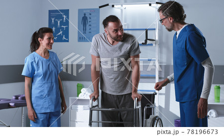 Handicapped man trying to stroll with walking frame near doctors 78196673