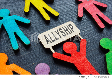 Small wooden figurine holding an inscription allyship. Small wooden figurine holding an inscription allyship. 78196901