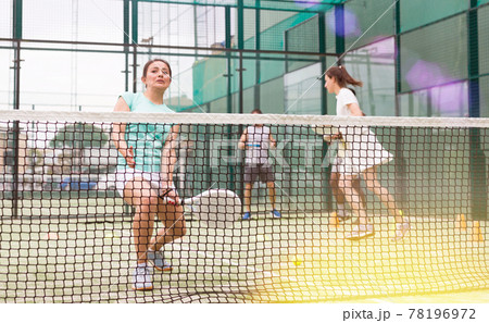 Active womans with enthusiasm playing padel on tennis court Active womans with enthusiasm playing padel on tennis court 78196972